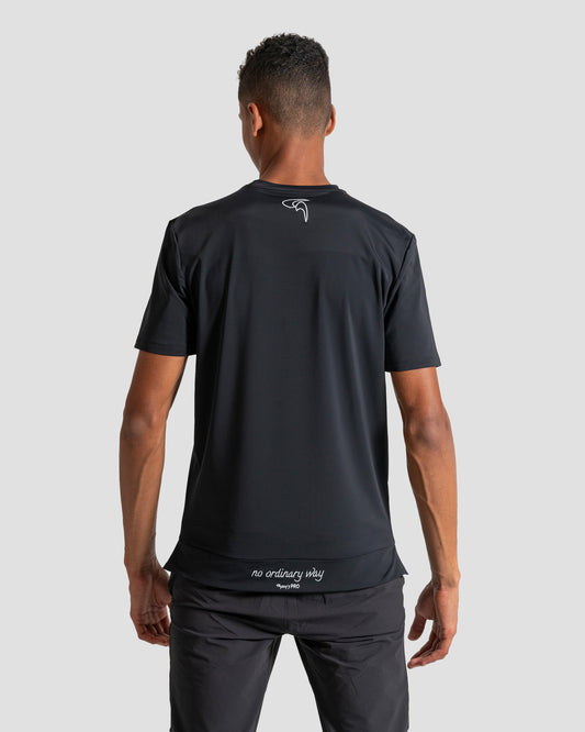 GoofyPRO Cayton Core Performance Tshirt in black with male model. White embroidered logo on neck and 'no ordinary way' on waistband. Worn by male model.
