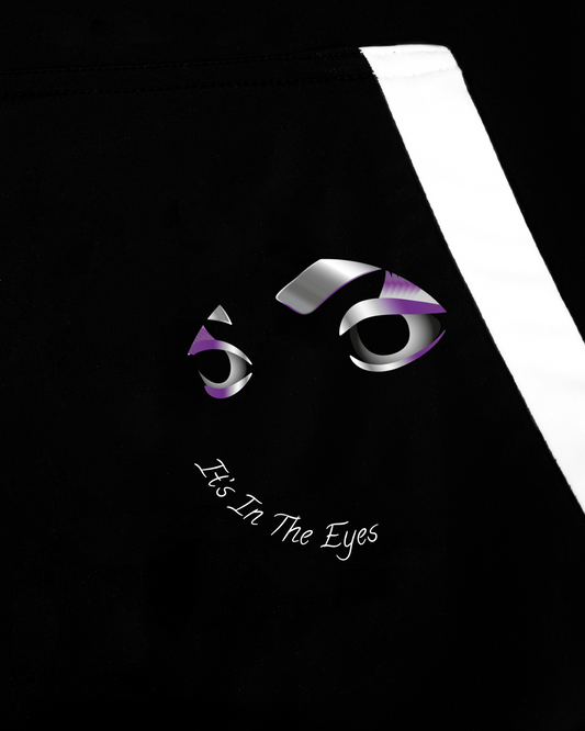 GoofyPRO Cayton XTR Hoodie in black. A close up of graphic on front pocket of one set of  eyes with It's in the Eyes in white, purple, silver. White trim on pocket.