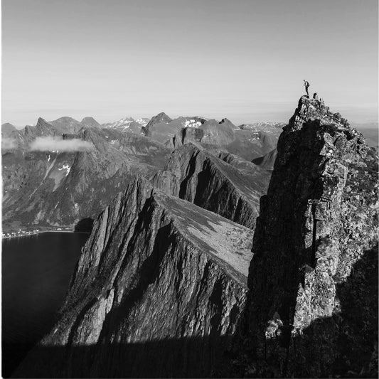 Person standing on top of a mountain