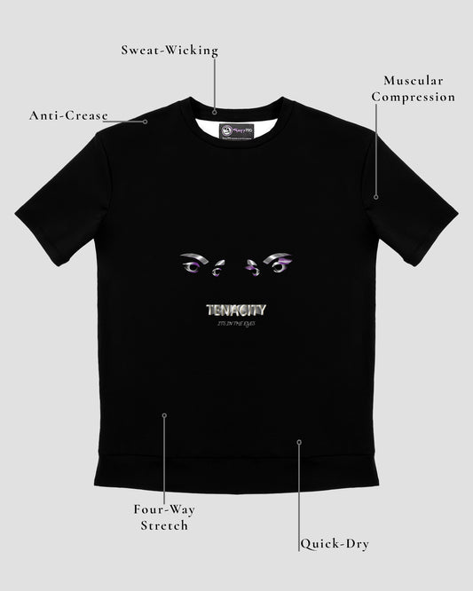 GoofyPRO Cayton Core Performance Tshirt in black with short sleeves. A graphic on front of two eyes with TENACITY It's in the Eyes in white, purple, silver and flecks of gold. Design elements of fabric.