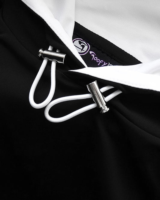 Close up of silver looking toggles on front of black Cayton Core hoodie.