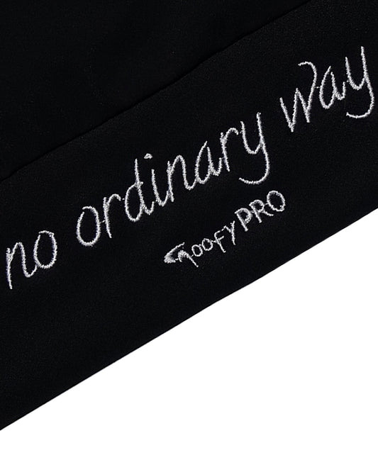 Close up of white embroidered waistband 'no ordinary way' on black Cayton Core hoodie.