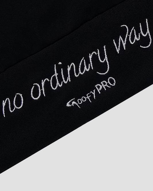 Close up of white embroidery on the back of a Cayton Core hoodie, in black.