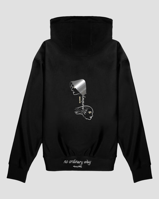 GoofyPRO Cayton XTR Hoodie in black. A graphic on rear of two faces with Do It NOW no ordinary way in silver, white and flecks of gold. White embroidered 'no ordinary way' on waistband. 