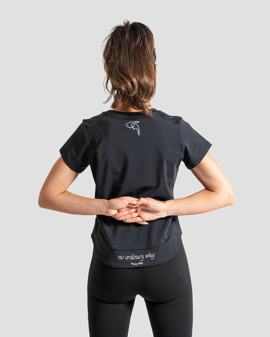 GoofyPRO Cayton Core Performance Tshirt in black with short sleeves, rear. White embroidered 'no ordinary way' in white on waistband. White embroidered logo at top of neck.