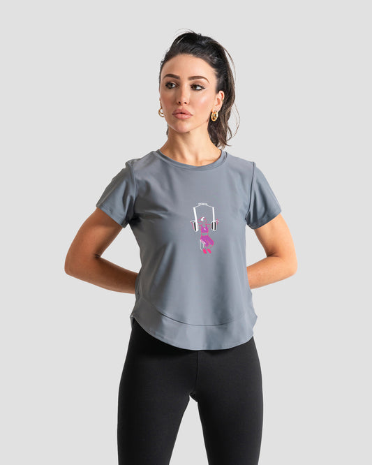 GoofyPRO Cayton Core Performance Tshirt in French grey with short sleeves. A graphic of a female using arm weight machine. worn by female model