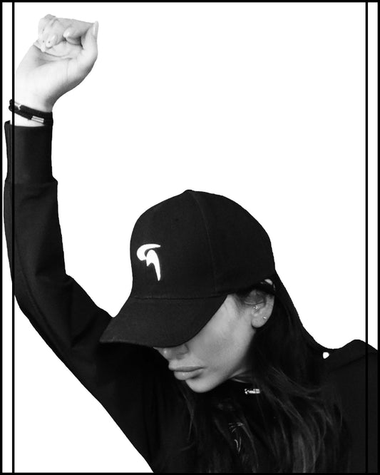 GoofyPRO XTR black Hoodie worn by female model -with Embroidered GoofyPRO logo on chest. Right arm raised.
